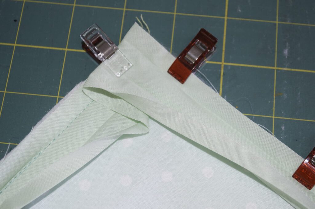 Continue Attaching the Binding to the Next Raw Edge Creating a corner Square How to sew bias binding
